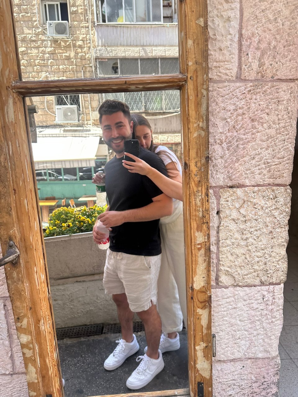 Gabriella and Joshua hugging in a stone doorway