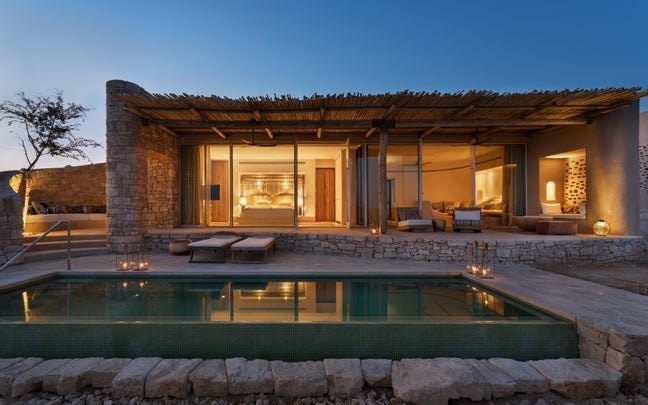 Panorama Pool Villa lit up at sunset with the private pool in front