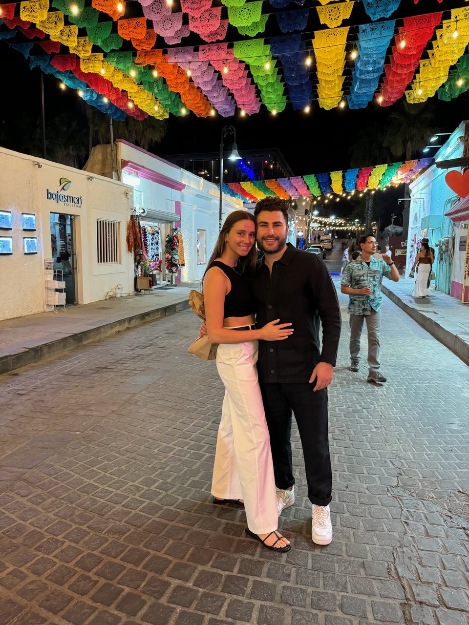 Strolling beneath colorful hanging umbrellas