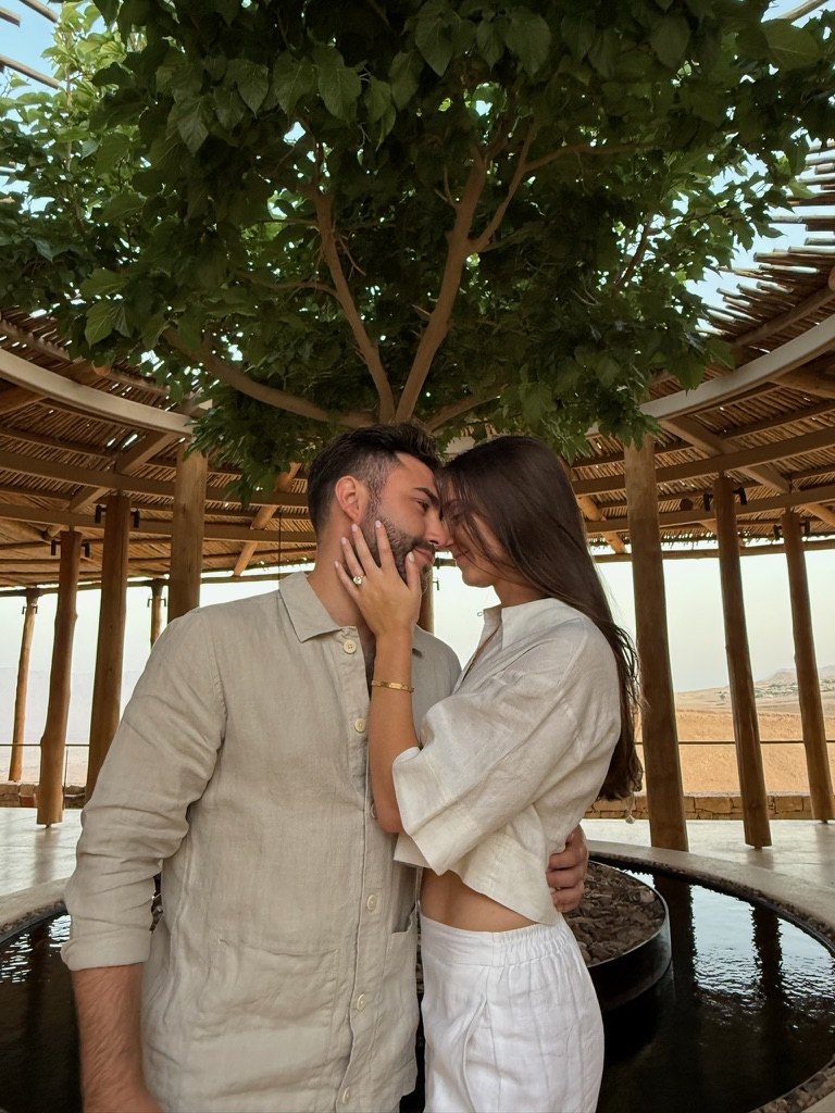 Gabriella and Joshua kissing beneath the pergola