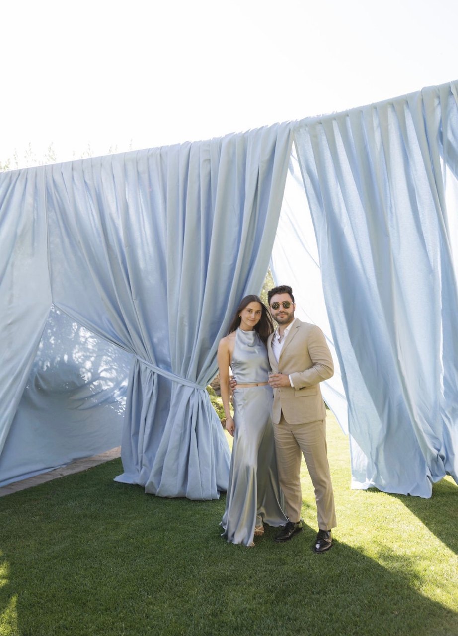 Beneath white drapery on the lawn