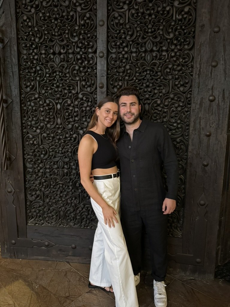 Gabriella and Joshua at an ornate carved doorway